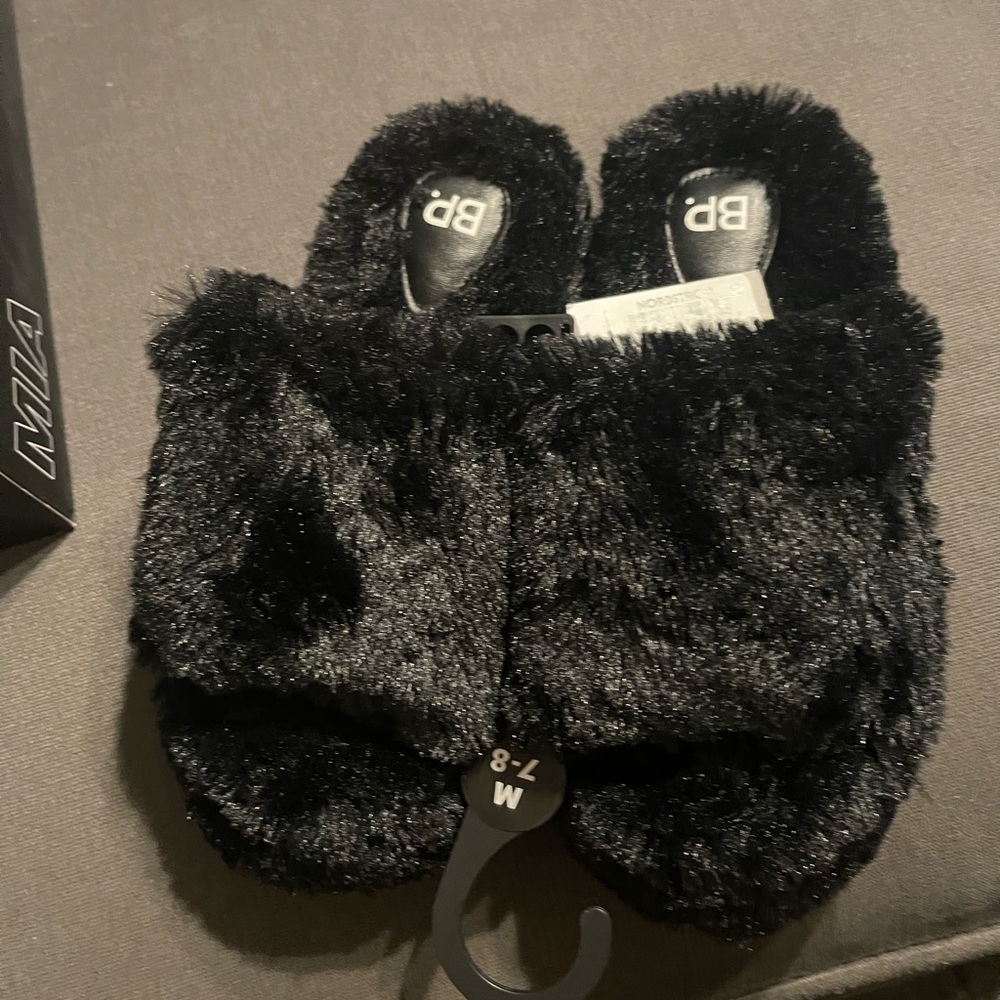 BP. Black furry slippers.